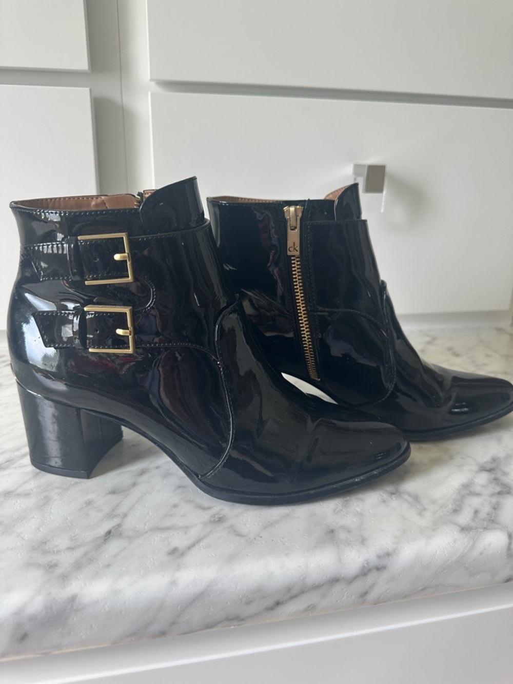 Calvin Klein Black Patent Ankle Booties with Gold Buckle Accents
